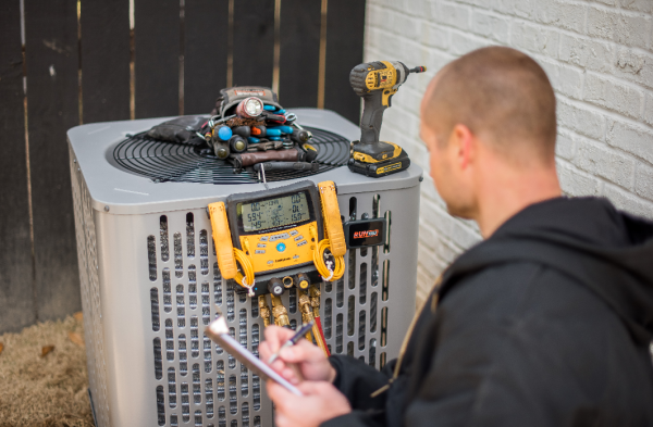 Skilled technician performing air conditioning repair